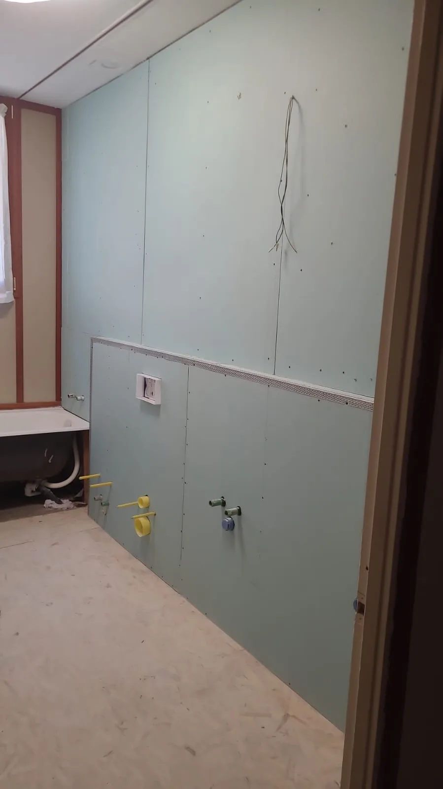 Pareti del bagno rifatte in cartongesso idrorepellente con le predisposizioni idrauliche a vista